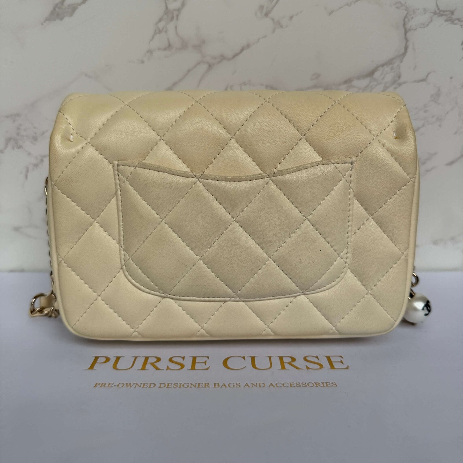 Back of the Chanel my precious pearl chain flap with Mona Lisa pocket