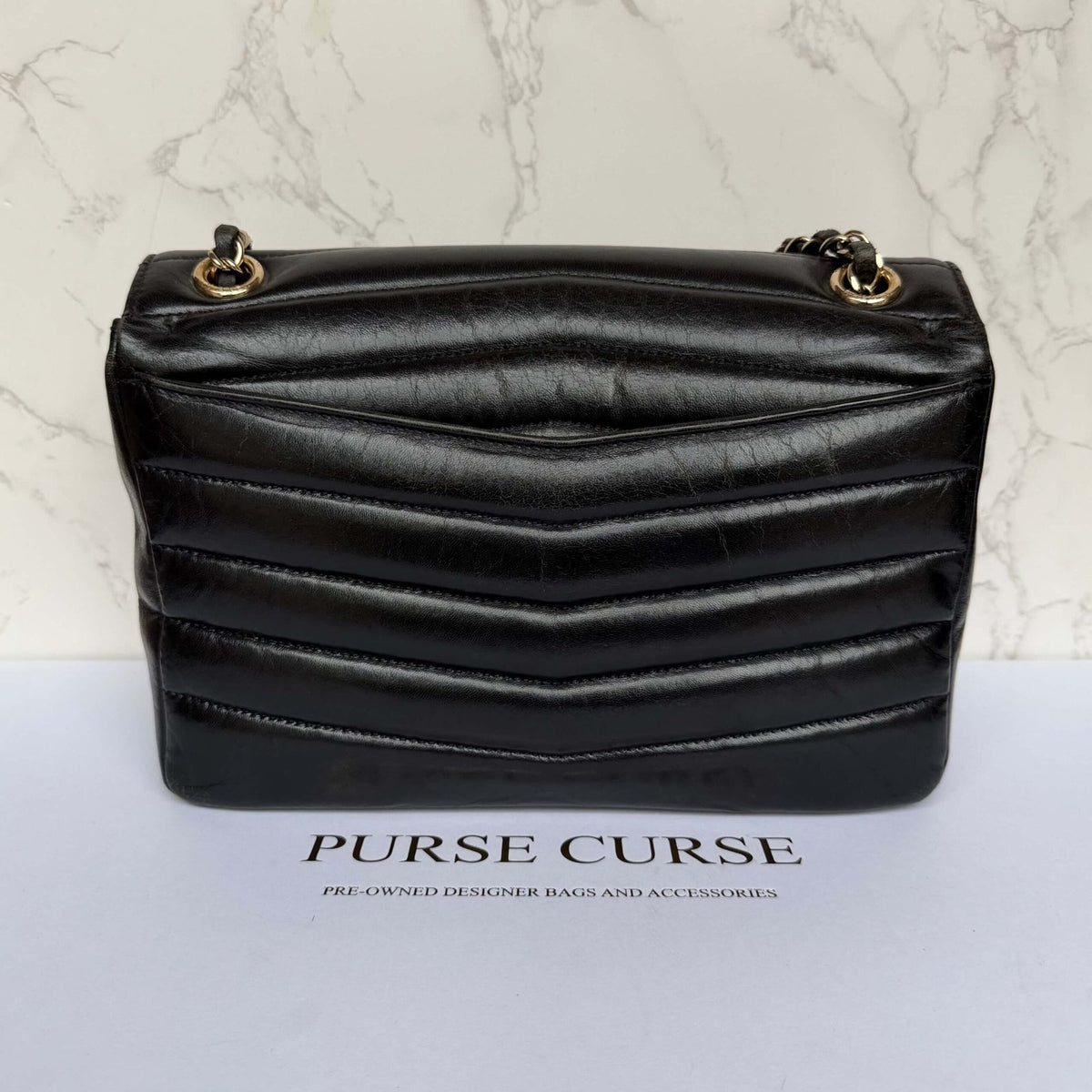 Back view black Chanel shiny calfskin flap bag