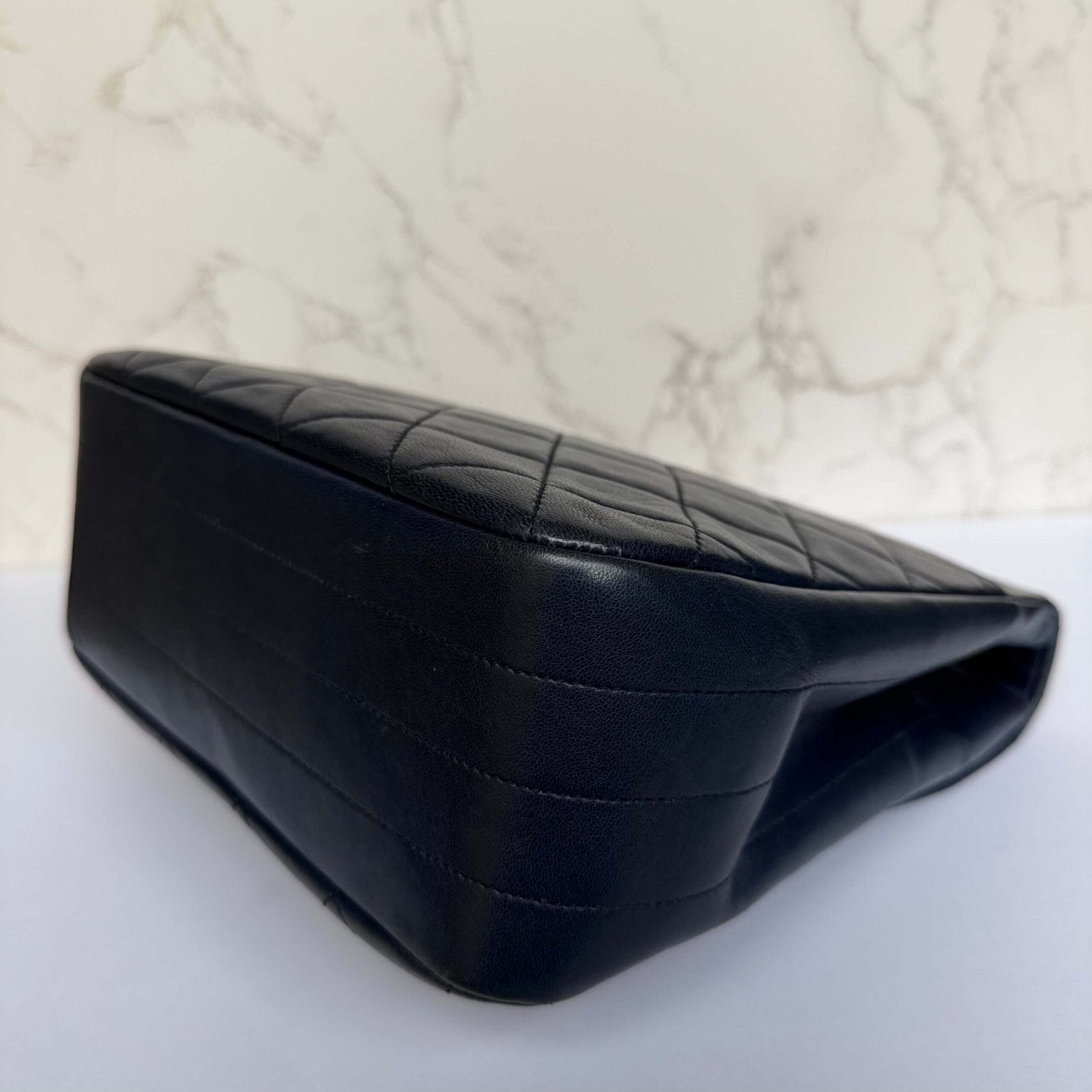 Corners with signs of wear on authentic vintage Chanel bag from the 1980s